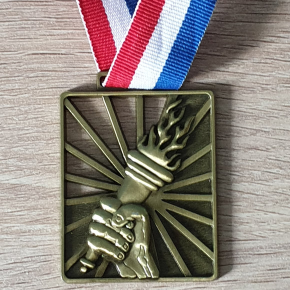 Playground to Podium medal: large gold rectangle depicting a fist holding up the flaming Olympic torch